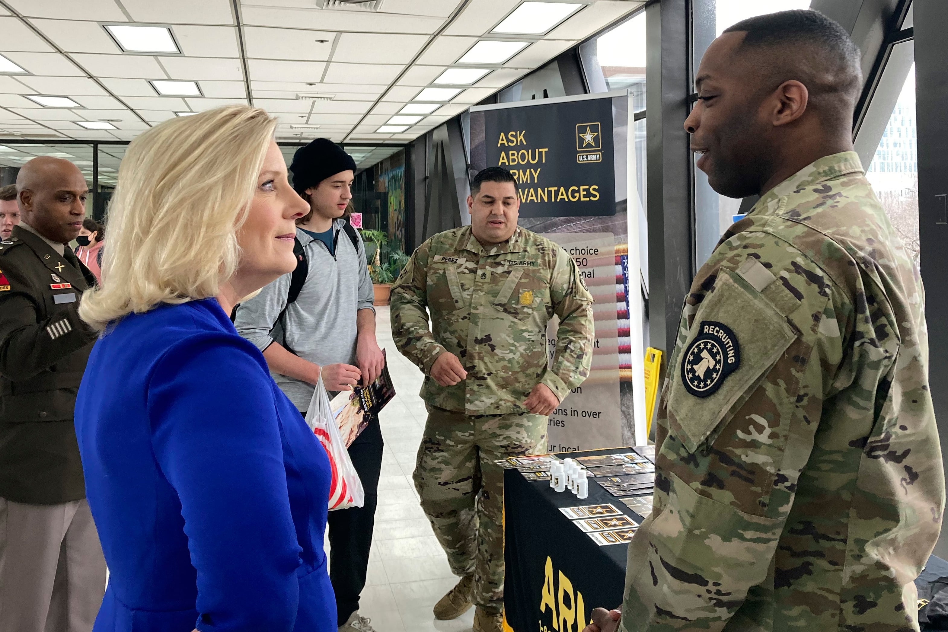 Army Secretary Christine Wormuth stops at an Army recruiting display after a speech to students at the Whitney M. Young Magnet High School in Chicago, on Feb. 14, 2023.